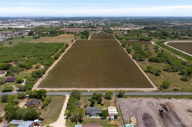 an aerial view of residential houses with outdoor space and swimming