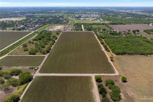 an aerial view of residential houses with outdoor space and river
