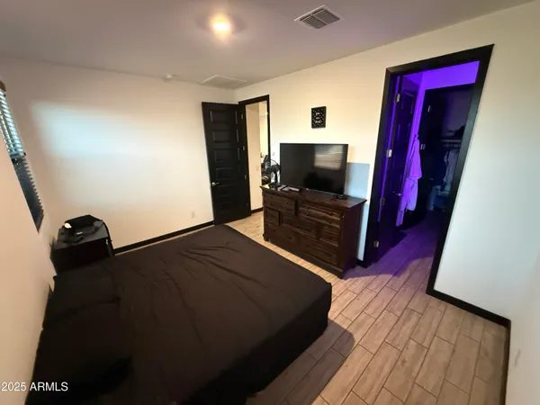 a bedroom with a bed and a flat screen tv