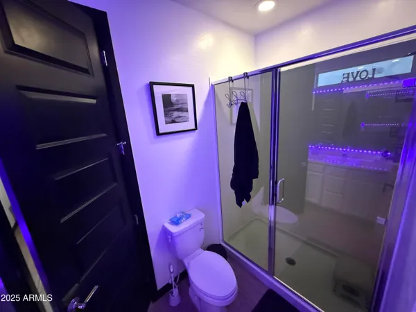a bathroom with a sink mirror vanity and toilet
