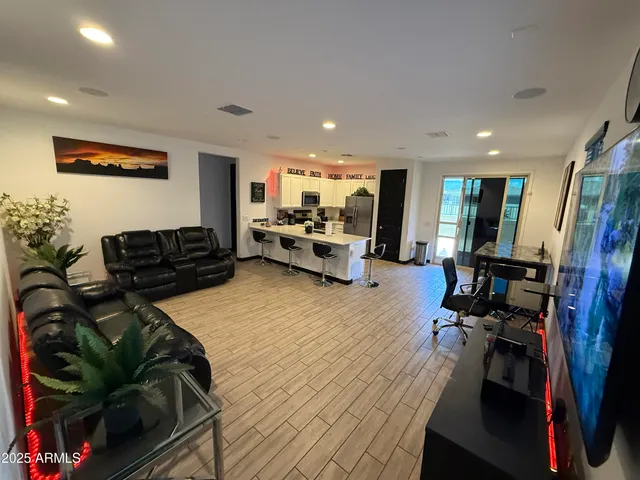 a living room with furniture and a wooden floor