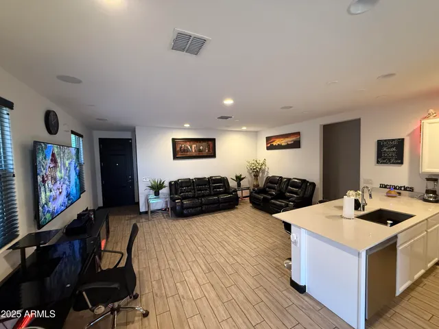 a living room with furniture and wooden floor