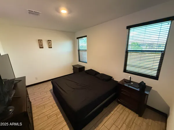 a bed sitting in a bedroom next to a window
