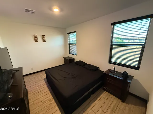 a bed sitting in a bedroom next to a window