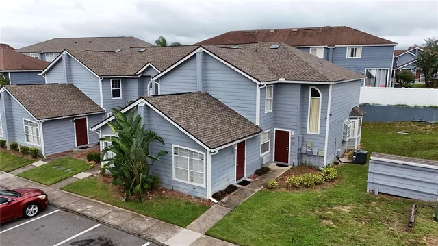 a aerial view of a house next to a yard