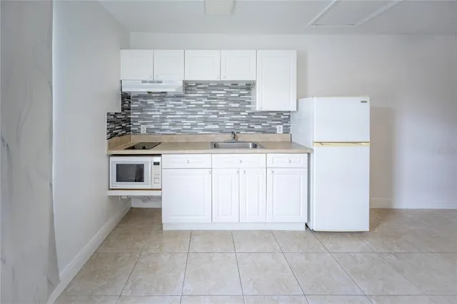 a kitchen with cabinets and white appliances