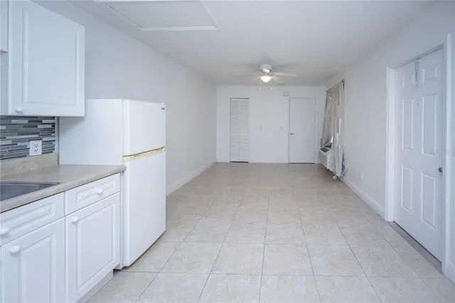 a view of a kitchen with white cabinets