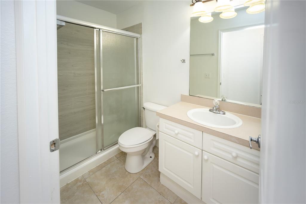 234 Mango Drive, Unit B Davenport, FL 33897 - Photo 6 of 17 a bathroom with a sink toilet and shower