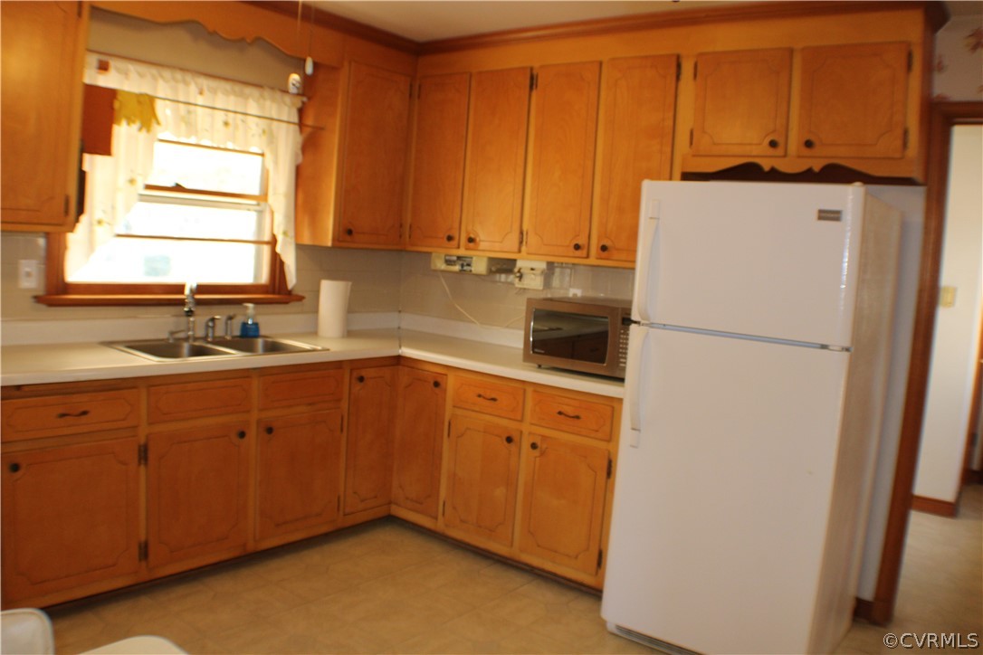 8132 Concho Road North Chesterfield, VA 23237 - Photo 14 of 32 a kitchen with a refrigerator and a sink