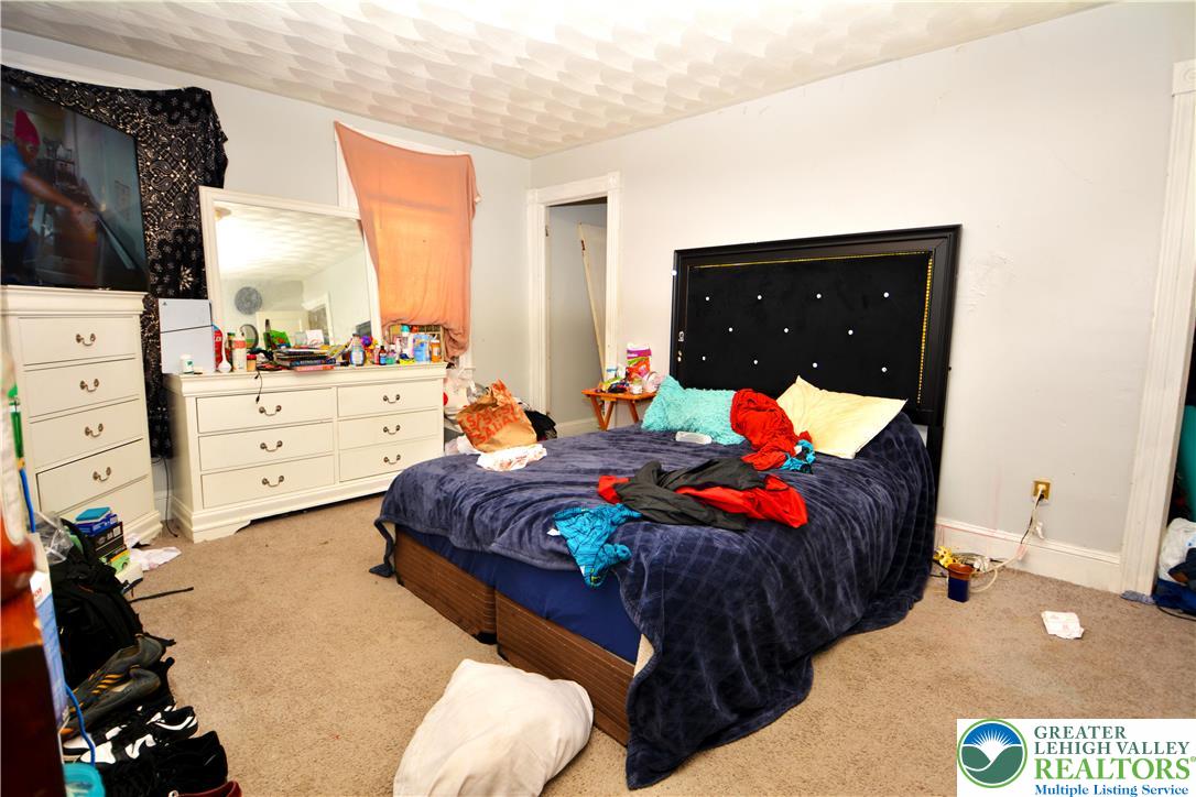 416 East Washington Street Nanticoke, PA 18634 - Photo 4 of 9 a bedroom with a bed and a mirror