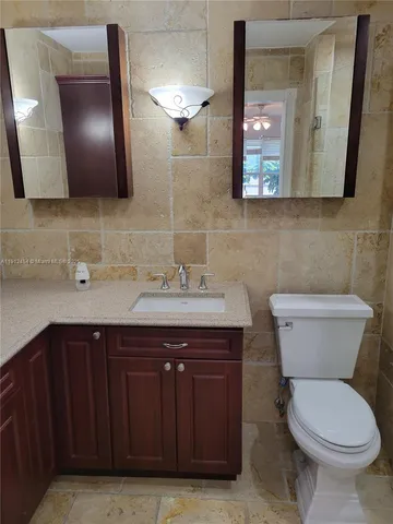 a kitchen with stainless steel appliances granite countertop a sink and a refrigerator