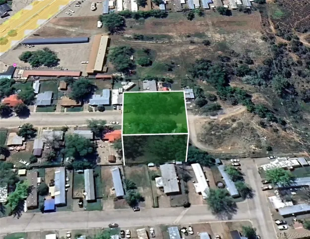 an aerial view of a house with a yard and large trees