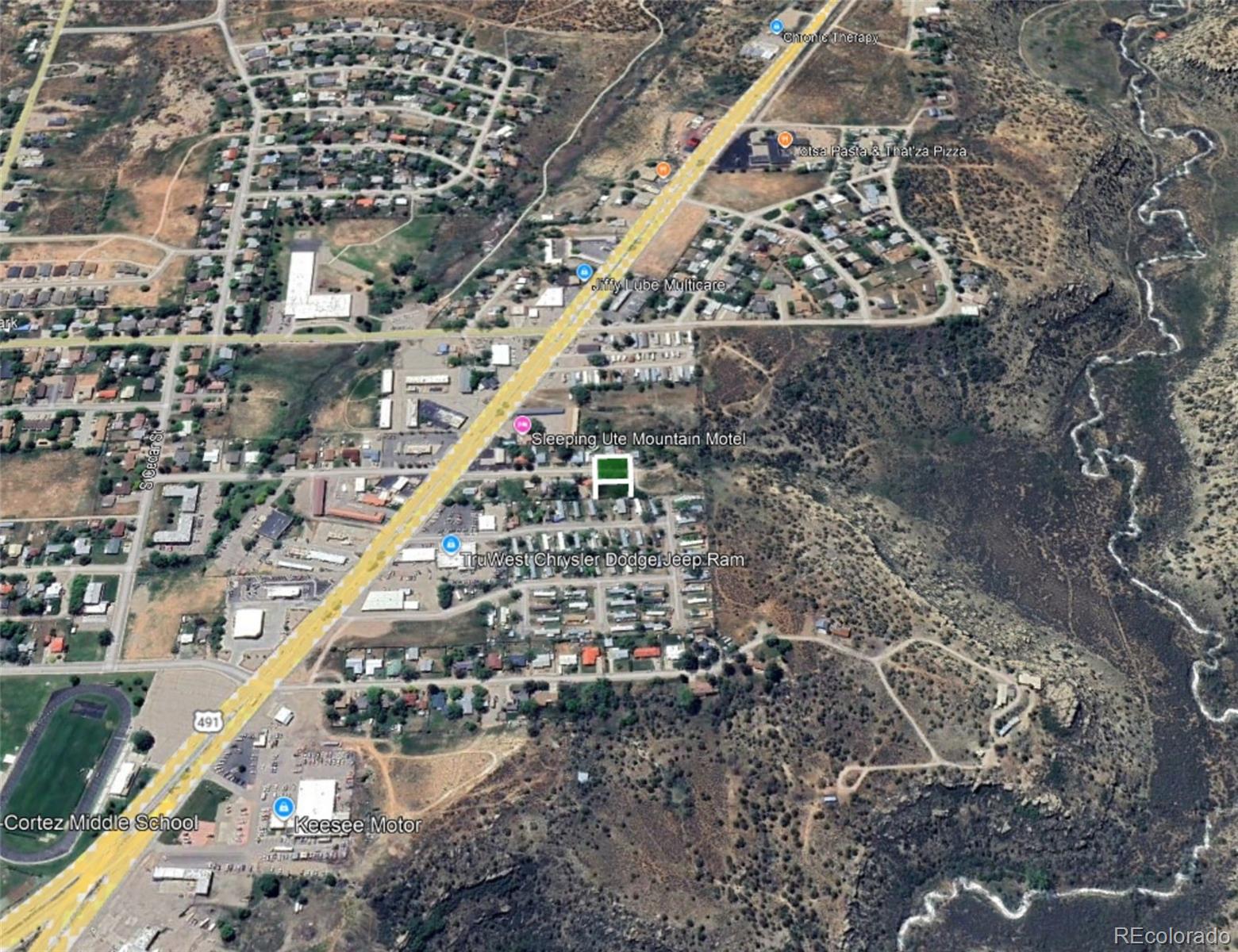 770 Stratton Drive Cortez, CO 81321 - Photo 5 of 6 a large building with a street view