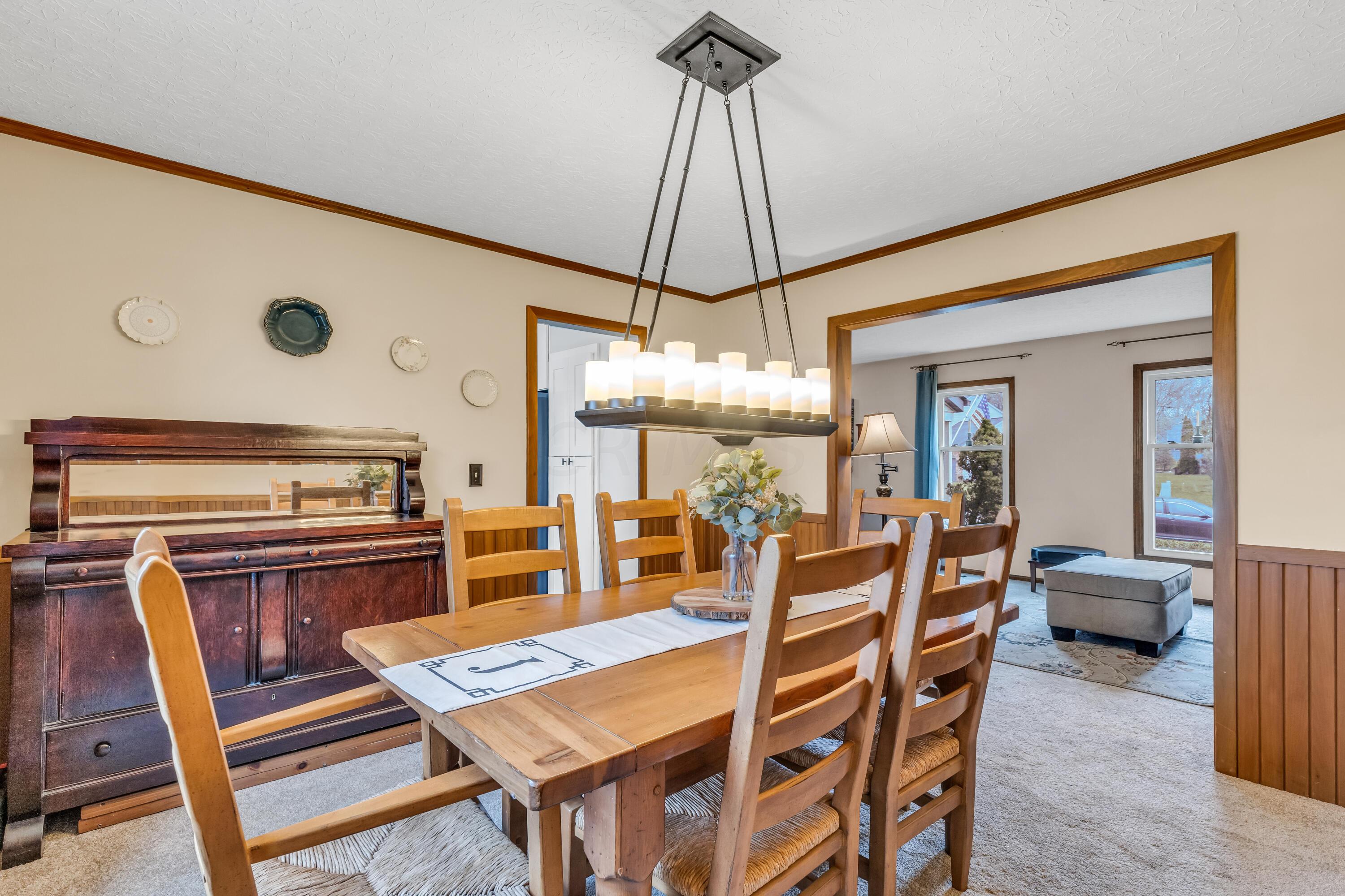435 Emory Street Gahanna, OH 43230 - Photo 14 of 54 • New light sand
carpet ~ 2022
• Vanilla painted & half
wainscoted walls
• Crown molding
• Chair railing
• New chandelier ~ 2020
• Drapes remain
