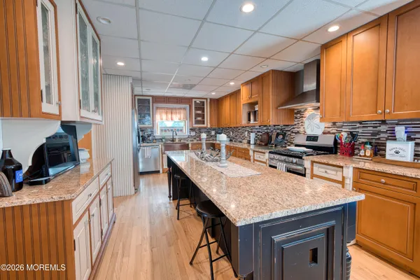 a kitchen with stainless steel appliances granite countertop sink stove top oven and cabinets