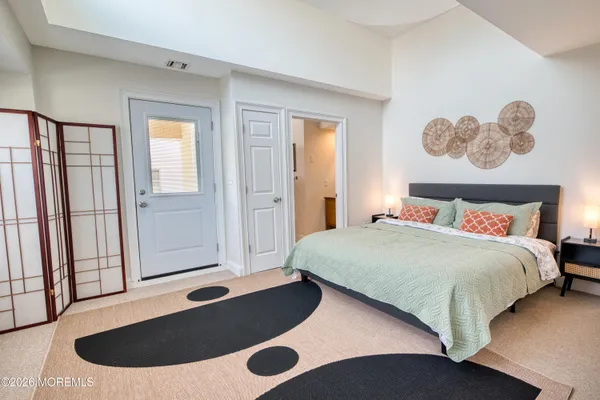 a bedroom with a bed and painting on the wall