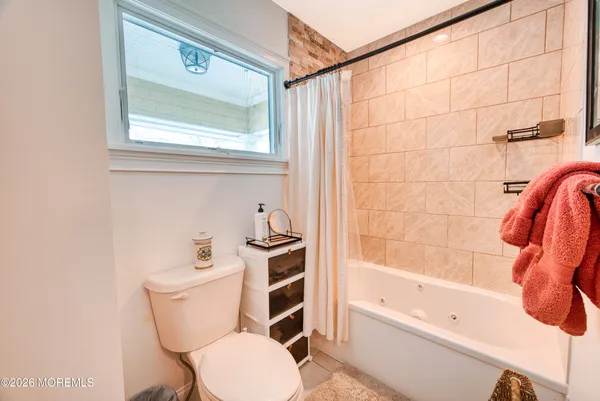 a bathroom with a toilet a sink and bathtub