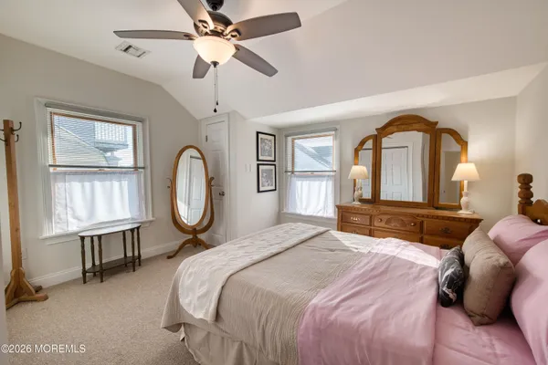 a bedroom with a bed large window with a chandelier
