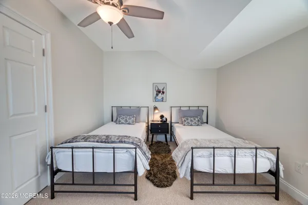 a bedroom with a bed a table and chandelier