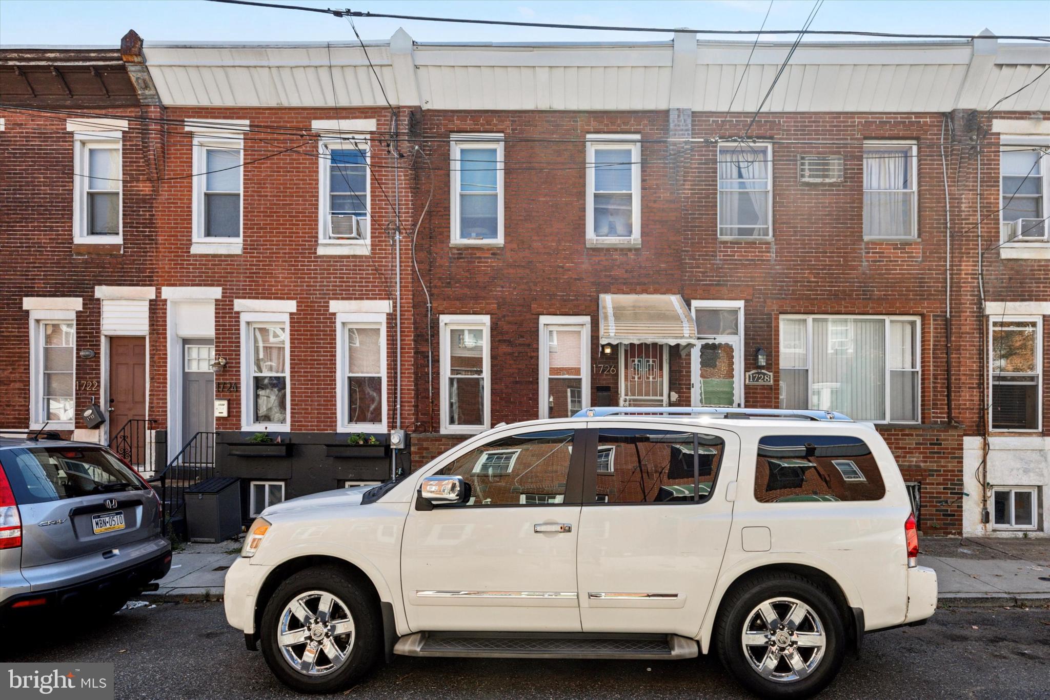 1726 Watkins Street Philadelphia, PA 19145 - Photo 1 of 15 a car parked in front of a building