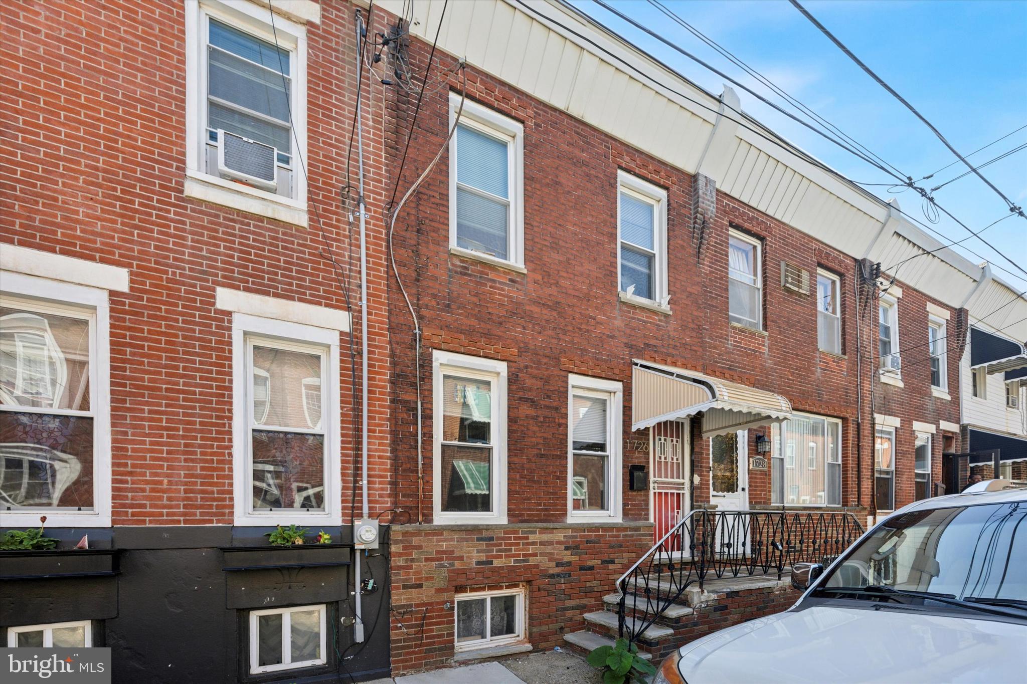 1726 Watkins Street Philadelphia, PA 19145 - Photo 2 of 15 a front view of a brick building with many windows