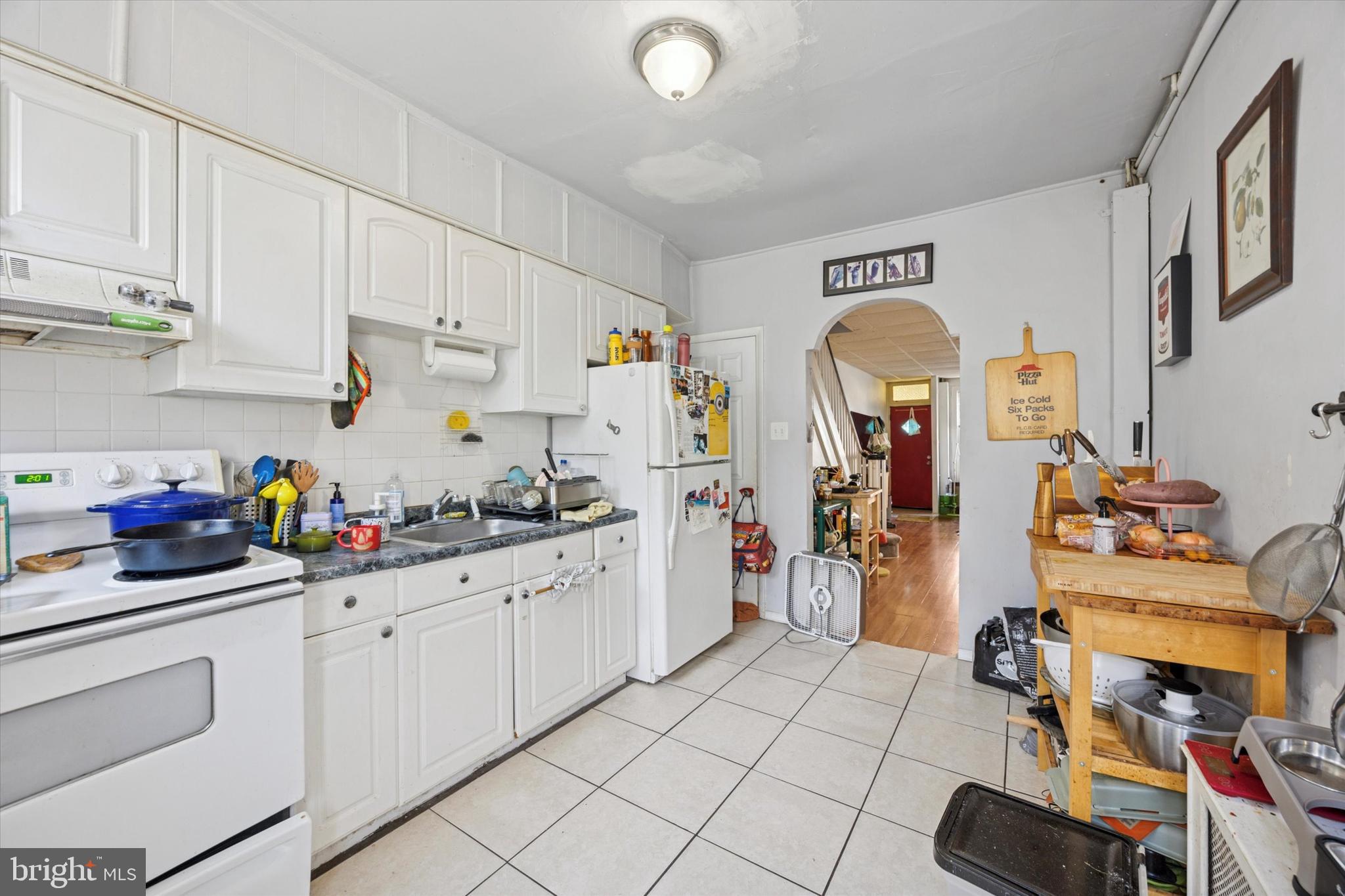 1726 Watkins Street Philadelphia, PA 19145 - Photo 7 of 15 a kitchen with a sink and cabinets