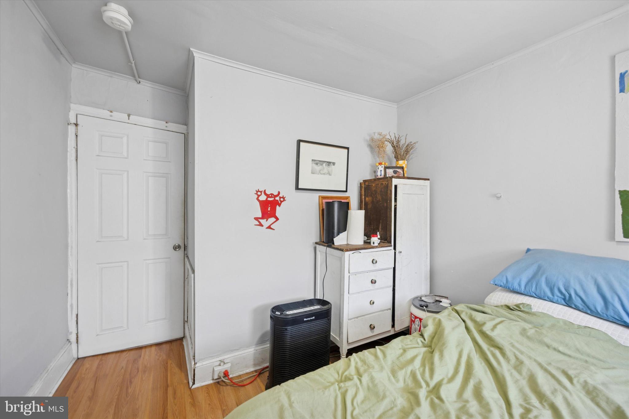 1726 Watkins Street Philadelphia, PA 19145 - Photo 9 of 15 a bedroom with a bed and wooden floor