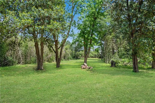 a view of outdoor space with green field and trees