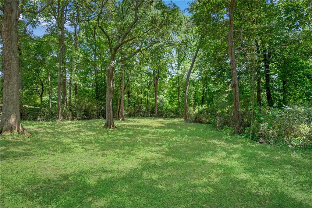 5387 Austell Powder Springs Road Southwest Austell, GA 30106 - Photo 9 of 11 a view of outdoor space with green field and trees