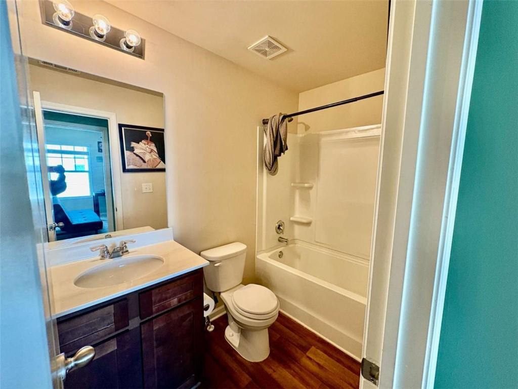 2176 Cypress Lane Southwest Atlanta, GA 30331 - Photo 14 of 17 a bathroom with a shower sink vanity mirror and toilet