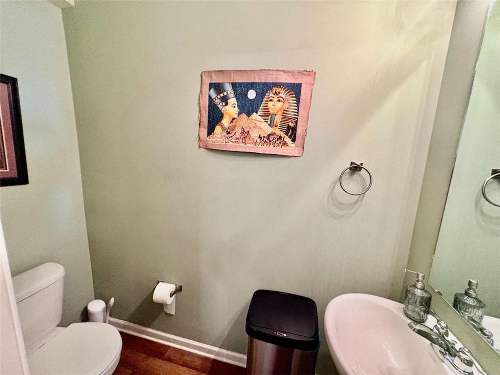 2176 Cypress Lane Southwest Atlanta, GA 30331 - Photo 4 of 17 a bathroom with a toilet a sink and a mirror