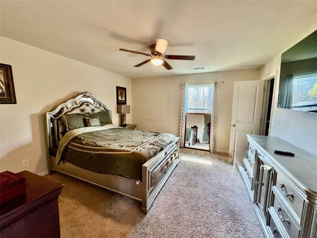 2176 Cypress Lane Southwest Atlanta, GA 30331 - Photo 8 of 17 a bedroom with a bed and a chandelier