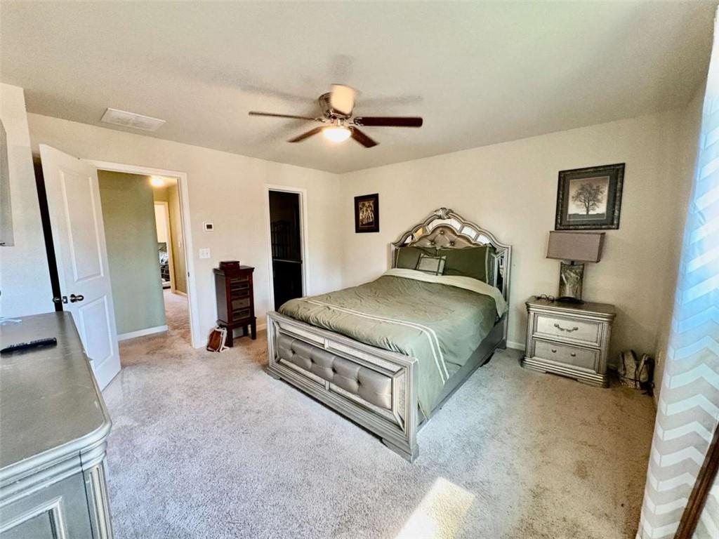 2176 Cypress Lane Southwest Atlanta, GA 30331 - Photo 9 of 17 a bedroom with a bed and a chandelier