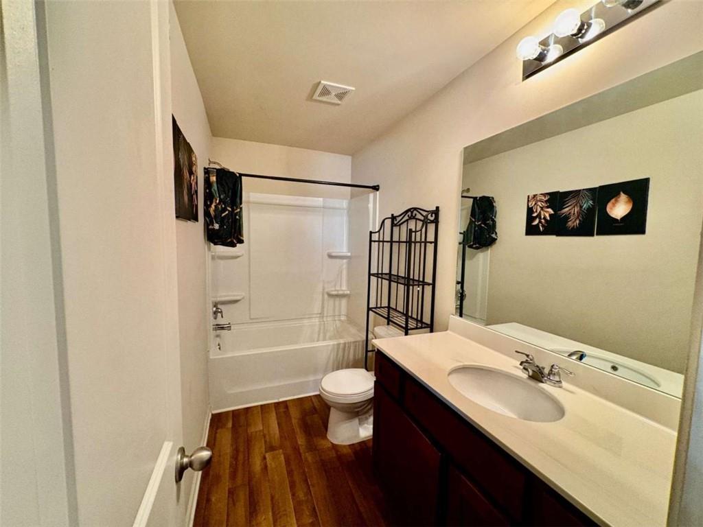2176 Cypress Lane Southwest Atlanta, GA 30331 - Photo 10 of 17 a bathroom with a sink a toilet a mirror and shower