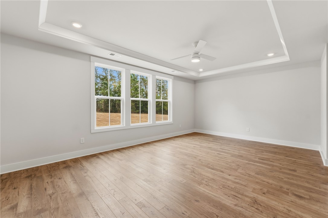 319 Summerall Drive Anderson, SC 29621 - Photo 15 of 37 This spacious room features elegant tray ceilings and rich hardwood flooring, creating a comfortable living space.