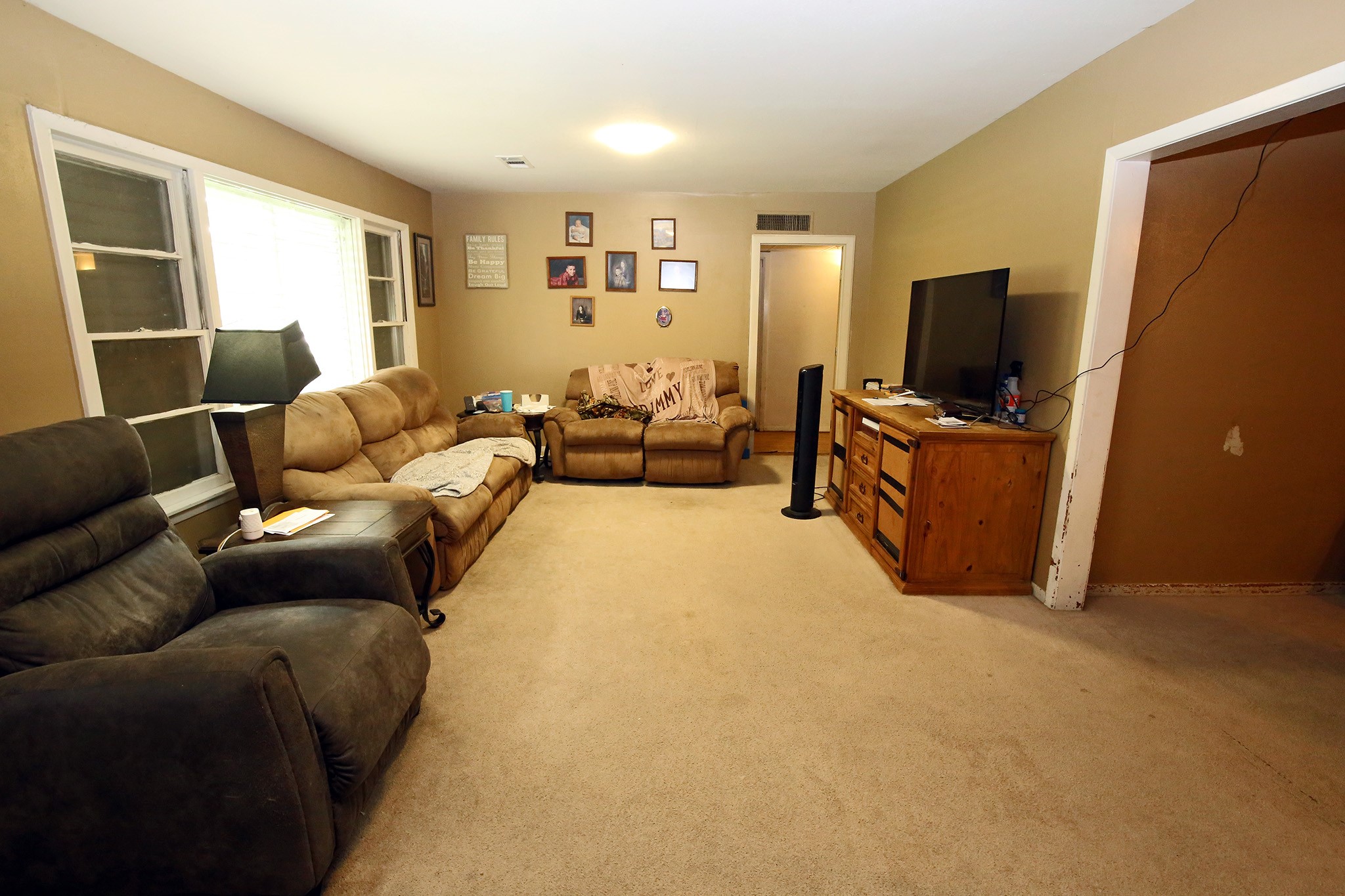 4406 FM 646 Road Santa Fe, TX 77510 - Photo 5 of 26 Living Room with Natural lighting coming through the windows. Big enough for that sectional!