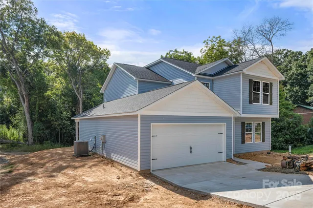 a view of a house with a yard and potted plants