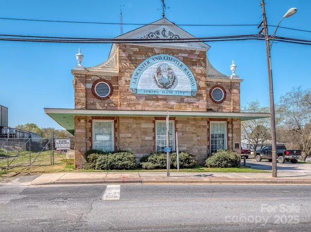 front view of a brick house with a yard