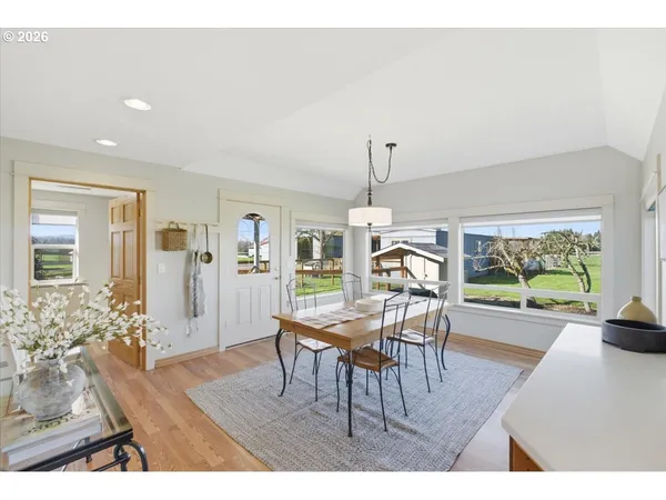 a dining room with furniture a chandelier and wooden floor