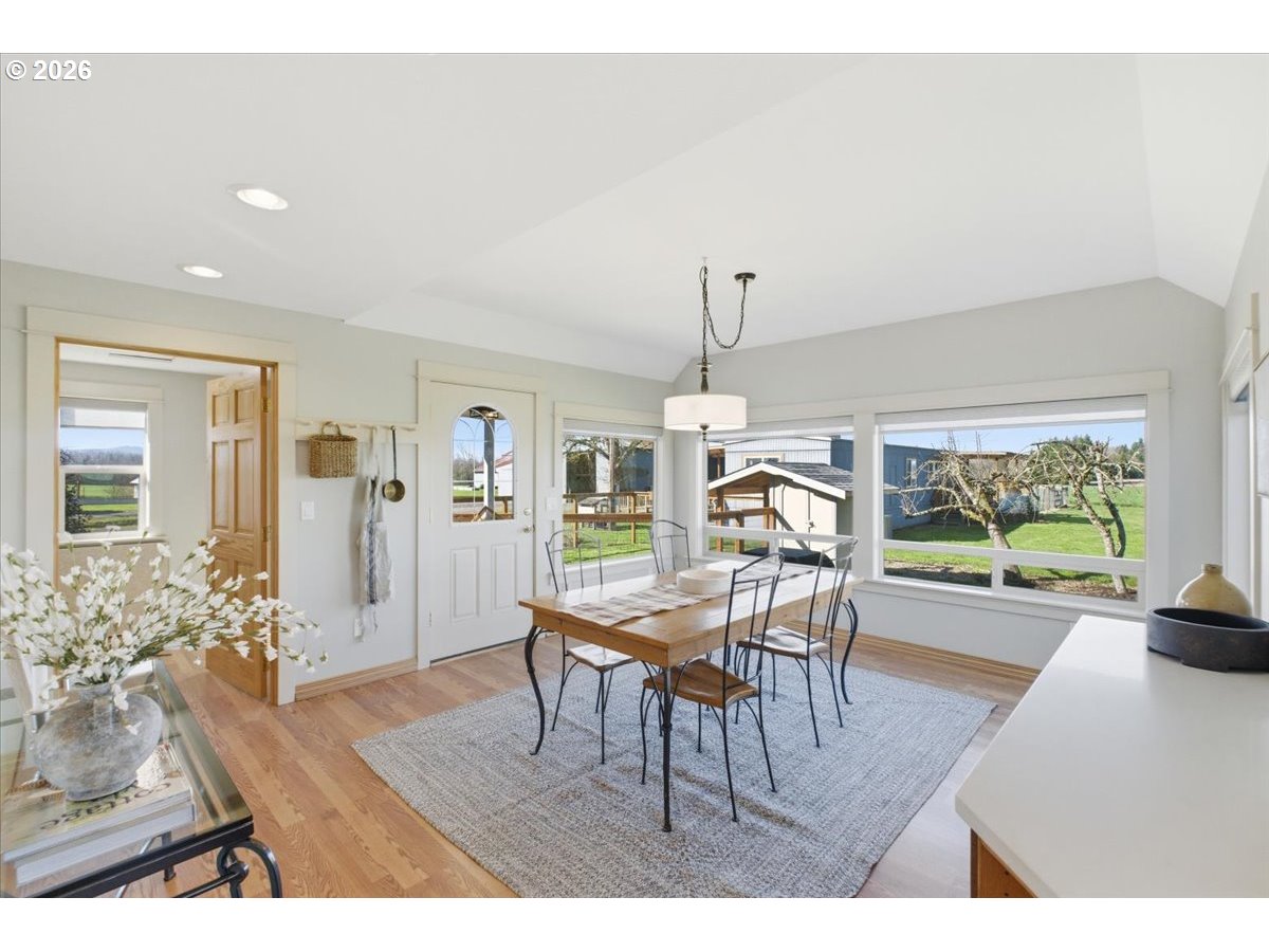 27144 Irish Bend Loop Halsey, OR 97348 - Photo 11 of 48 a dining room with furniture a chandelier and wooden floor