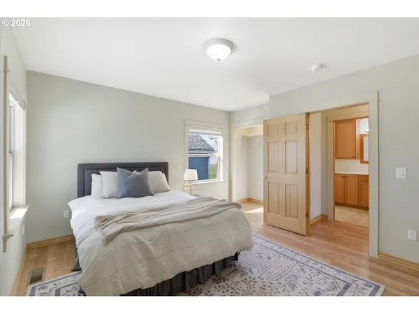 a bedroom with a bed and wooden floor