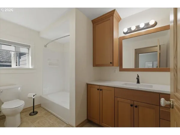 a bathroom with a toilet sink vanity and mirror