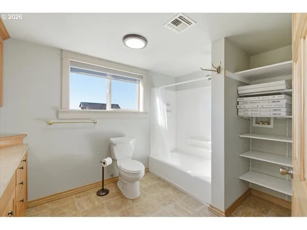 a bathroom with a toilet sink a mirror and shower