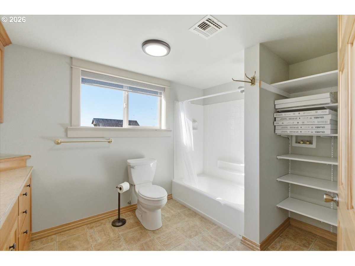 27144 Irish Bend Loop Halsey, OR 97348 - Photo 19 of 48 a bathroom with a toilet sink a mirror and shower