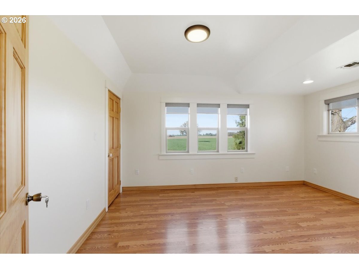 27144 Irish Bend Loop Halsey, OR 97348 - Photo 21 of 48 a view of an empty room with wooden floor and a window