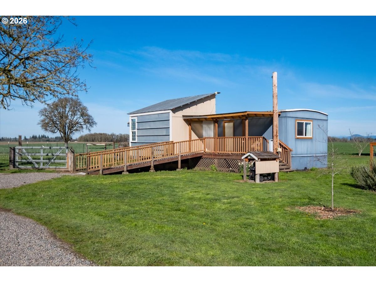 27144 Irish Bend Loop Halsey, OR 97348 - Photo 38 of 48 a backyard of a house with table and chairs