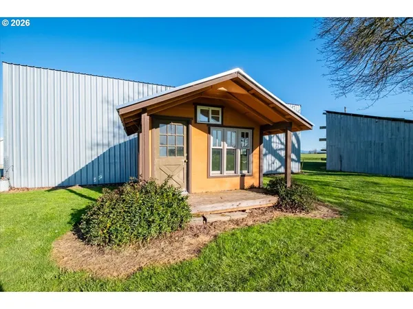 a view of a backyard with wooden fence