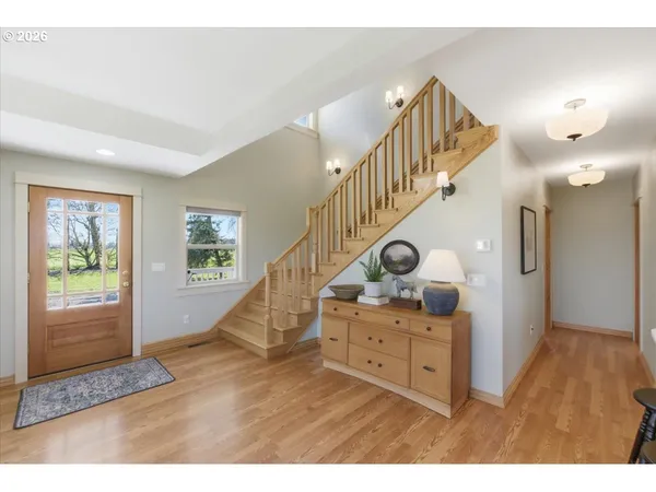 a view of entryway livingroom and hall with wooden floor