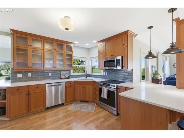 a kitchen with stainless steel appliances granite countertop a stove sink and cabinets