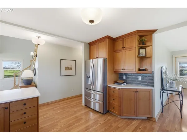 a kitchen with stainless steel appliances granite countertop a refrigerator a stove and a sink